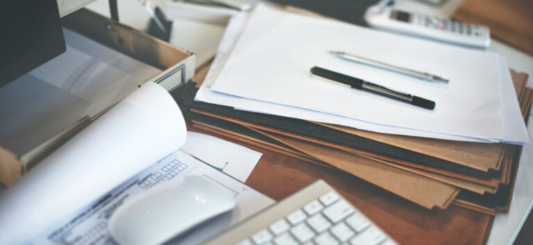 Documents on a table waiting to be scanned
