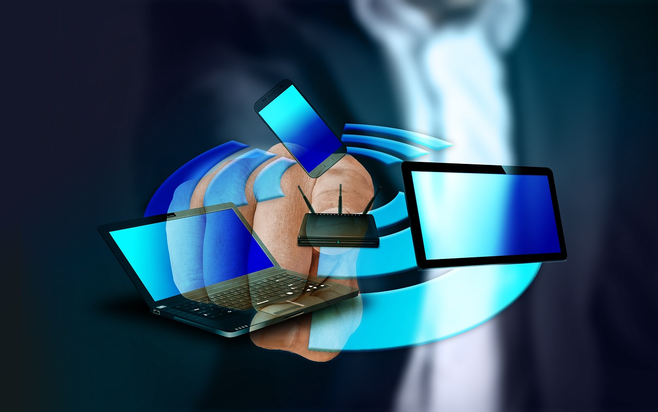 Hand holding various wireless devices including a laptop, smartphone, tablet, and router with Wi-Fi signal illustration