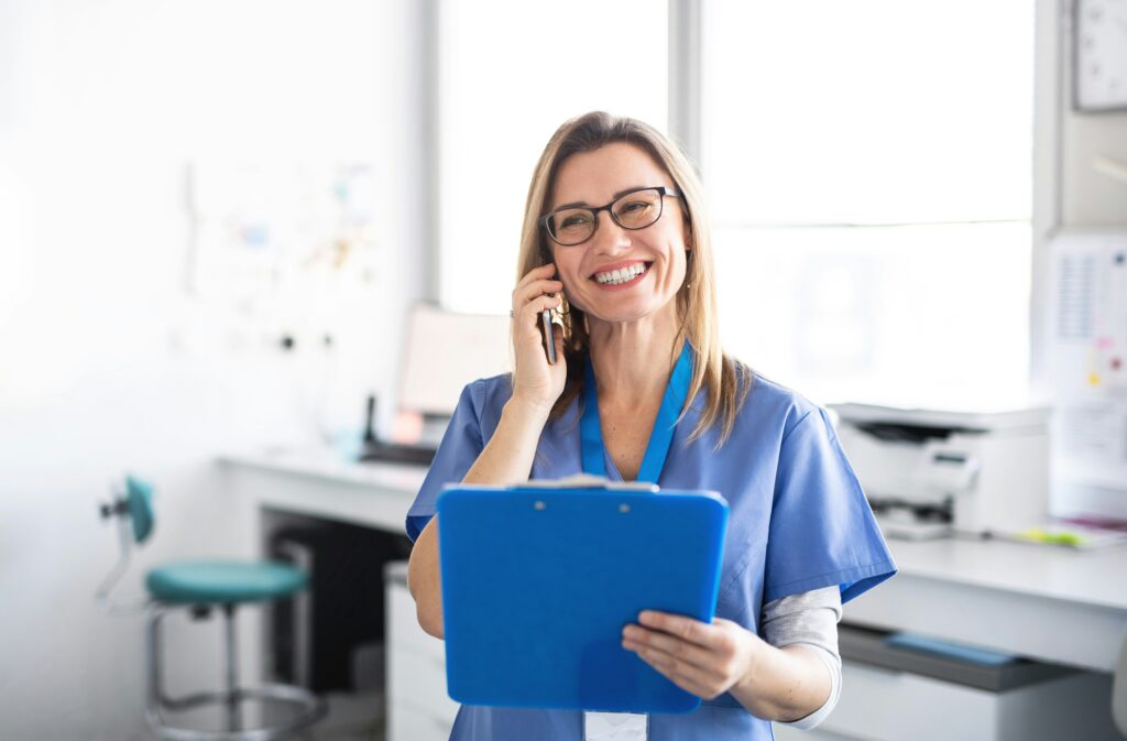 Healthcare worker on the phone with a clipboard